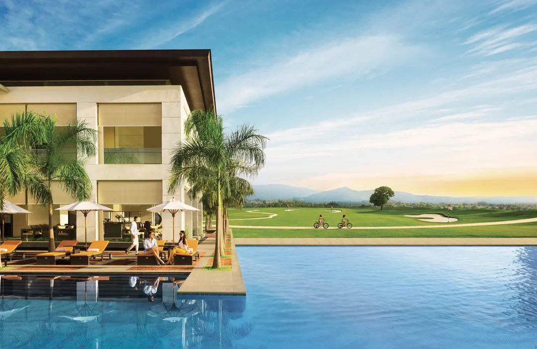 Residents by a clubhouse pool overlooking the golf course